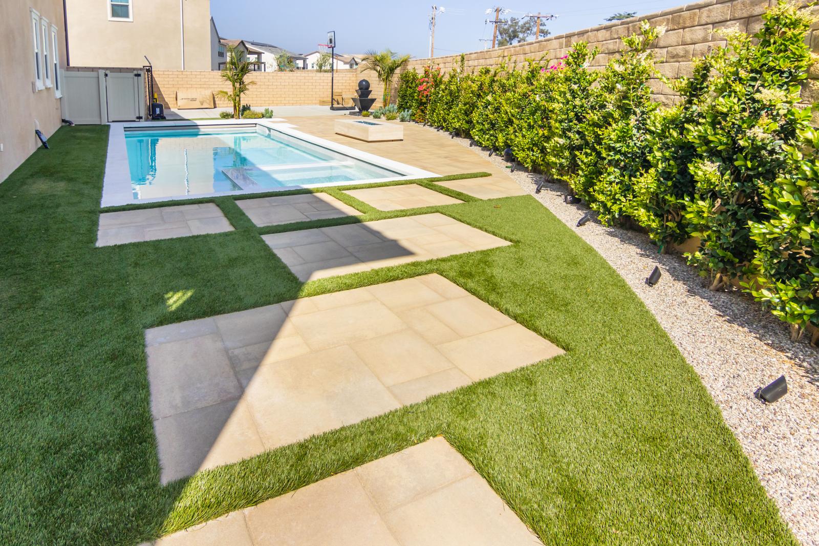 Modern pool with fire feature and landscape design in Sterling Ranch by Pool Masters LA — photo 2