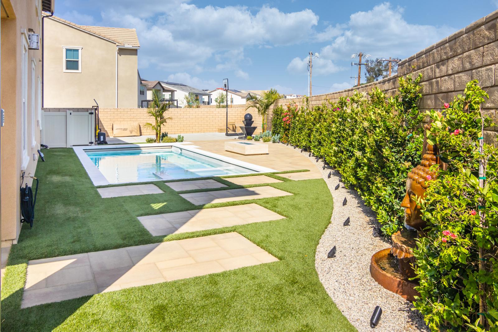 Modern pool with fire feature and landscape design in Sterling Ranch by Pool Masters LA