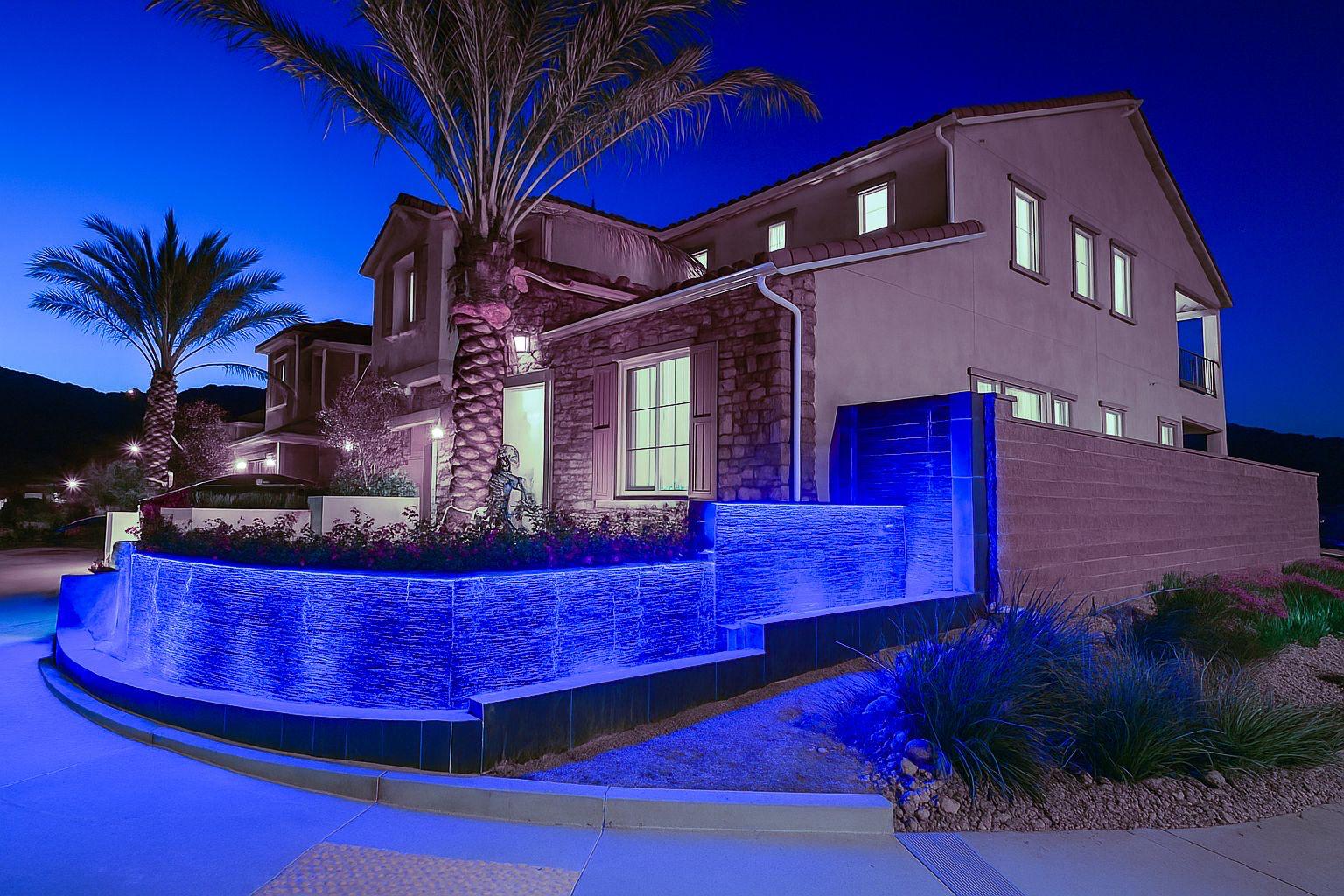 Luxury custom home with blue-lit water feature in Sterling Ranch by Pool Masters LA