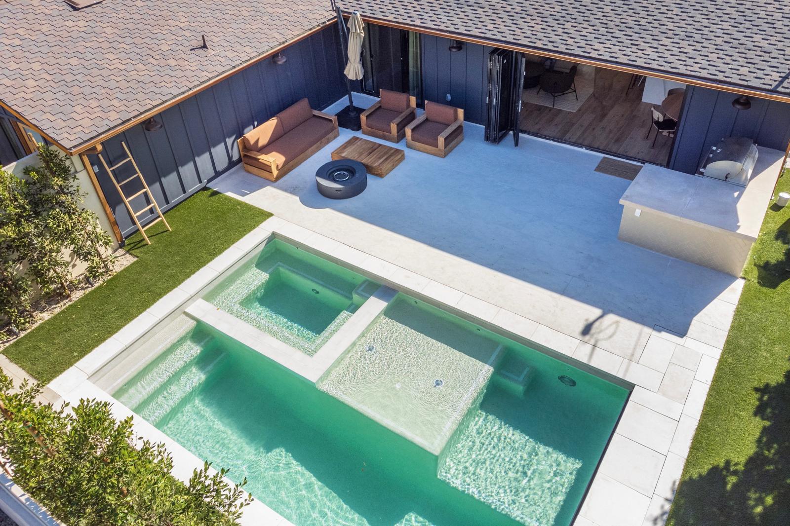 Modern custom pool and spa with outdoor lounge in San Fernando Valley by Pool Masters LA